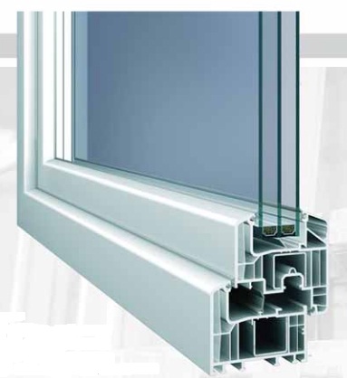 A close product rendering shows a white window frame angled from the upper-left toward a multi-chamber cutaway at the lower-right. Several narrow vertical glass layers with dark and green-gray edges rise above the profile. The image uses cool white and blue-gray tones and contains no visible text.