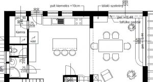 A black-and-white architectural floor plan shows an open kitchen, dining, and living area. Dimension lines and room labels surround the outlined walls. Furniture symbols include a dining table, chairs, sofa, and kitchen cabinets.