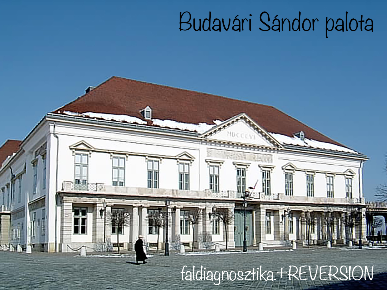 Snow edged facade of Budavári Sándor Palace with a long colonnade.