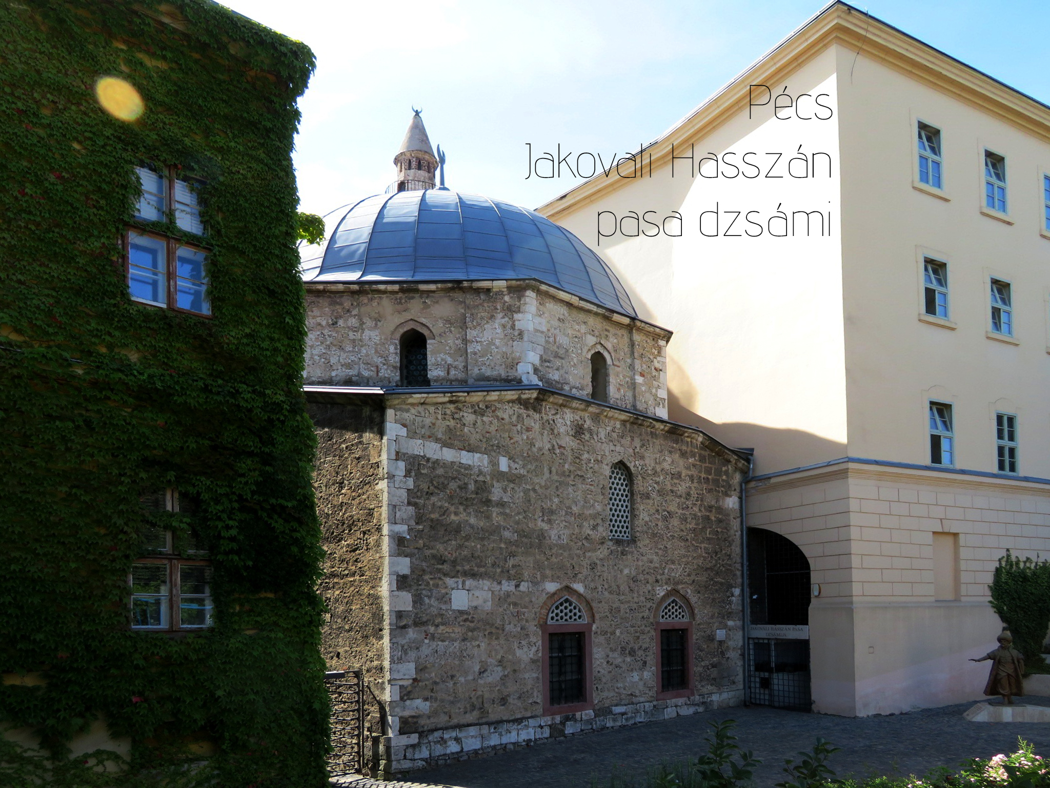 Stone Jakovali Hasszan pasa mosque with dome and minaret in a Pécs courtyard.