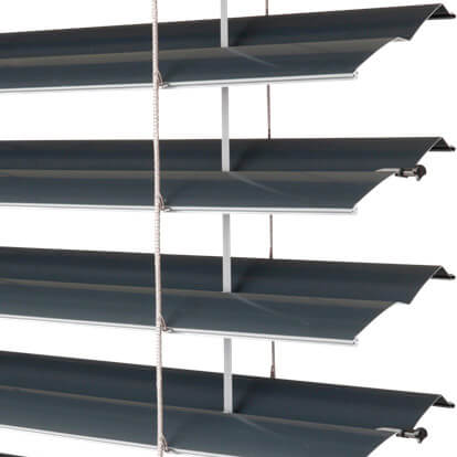 A close-up shows four dark gray horizontal slats arranged with gaps between them. Their front edges curve slightly and appear to angle upward toward the right. Thin vertical cords and support strips run through the assembly against a white background.