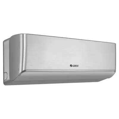 A silver-gray wall-mounted air-conditioning unit fills most of the frame in a three-quarter view. Its broad front panel has a brushed-metal appearance, while the left side and lower outlet are also visible. A small centered logo reads "GREE". The product is isolated against a white background.
