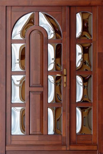 Brown double entrance door with reflective decorative glass panels.