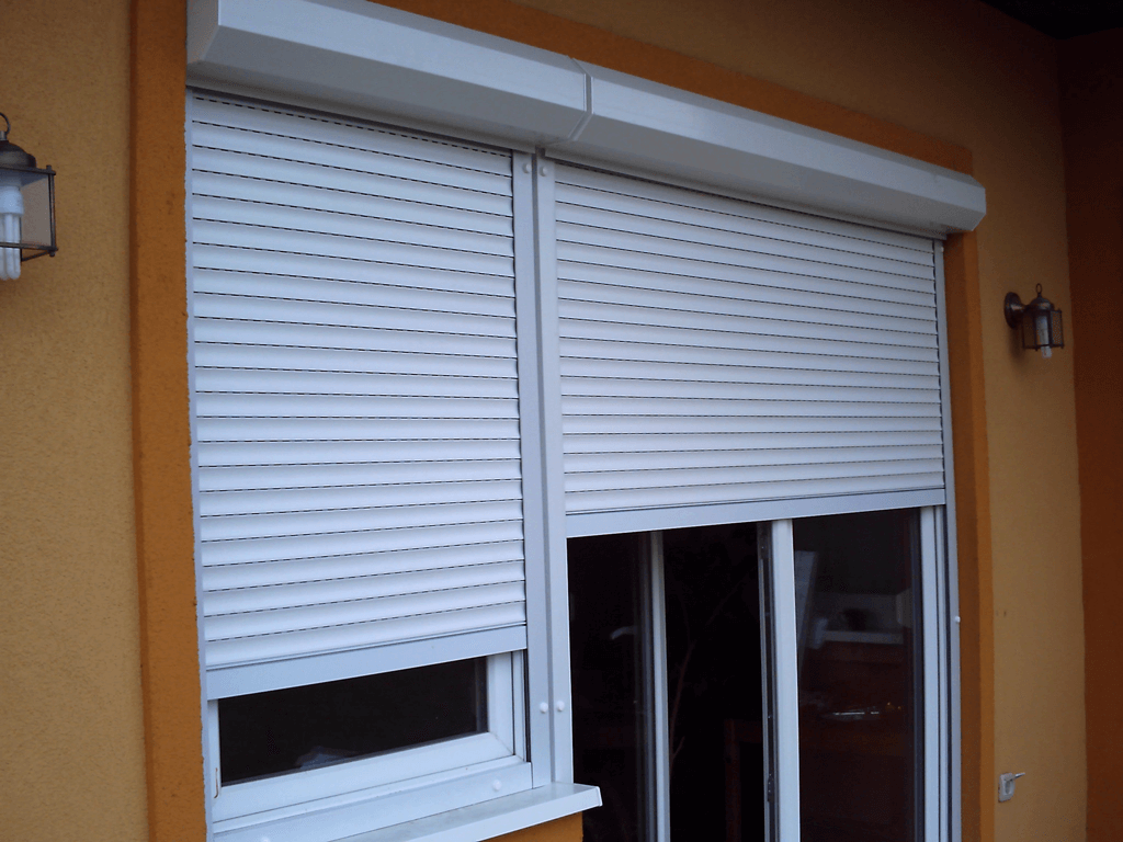 Exterior white roller shutter partly covering a house window.