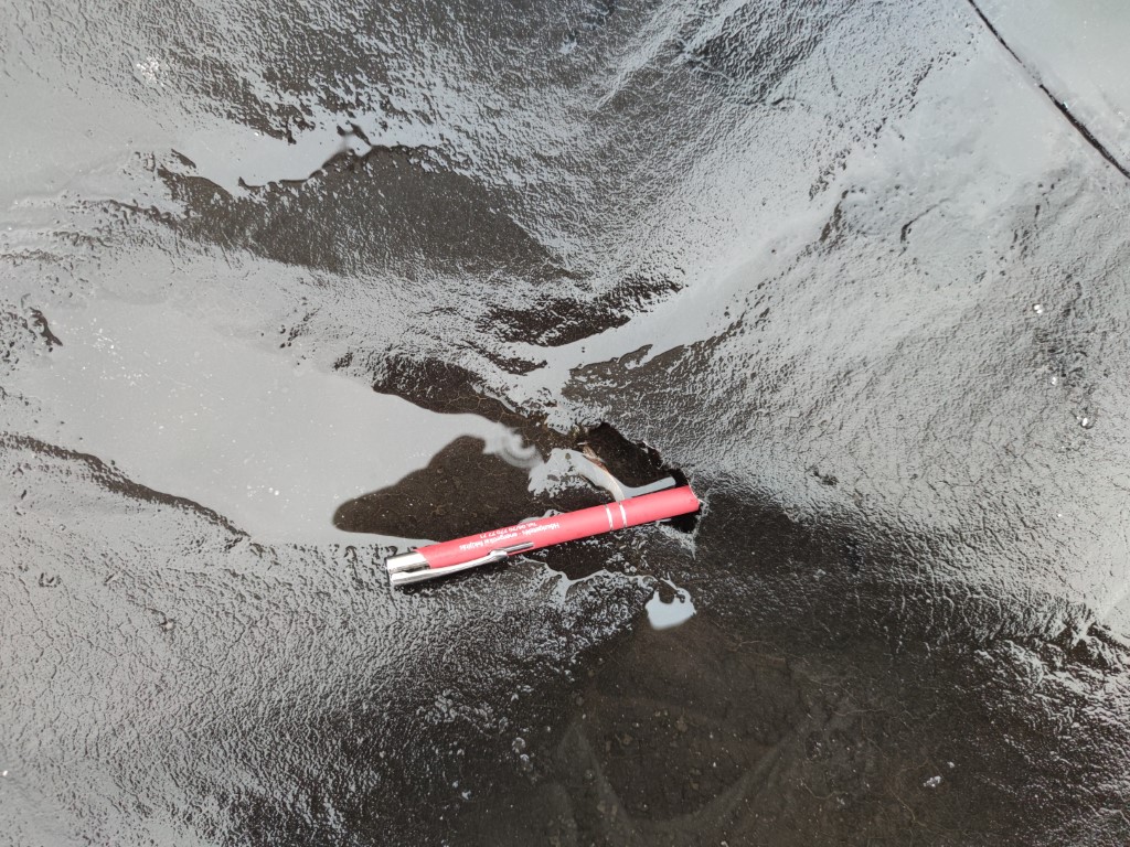Flat roof waterproofing work viewed from above.