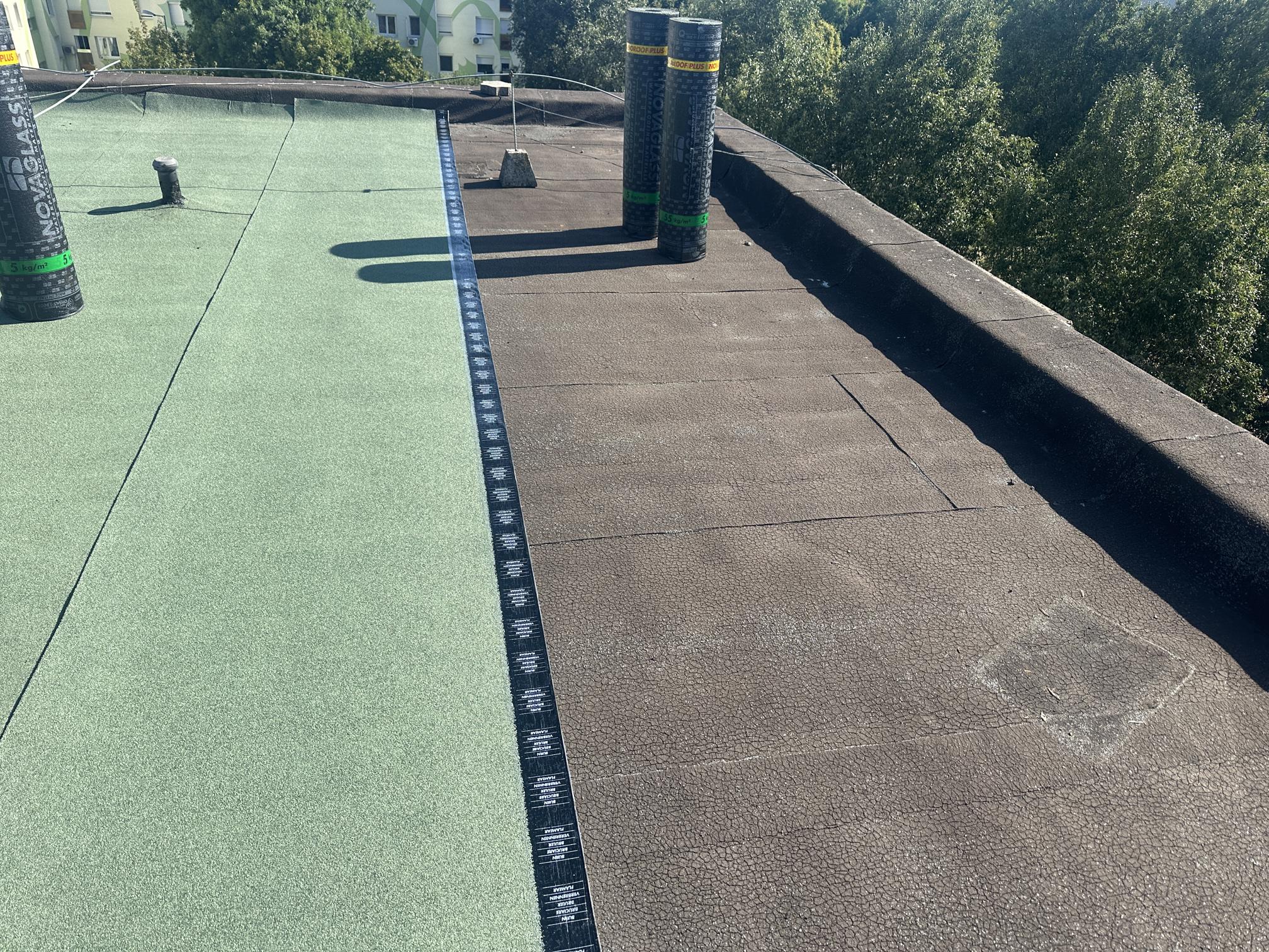 Flat roof waterproofing work viewed from above.
