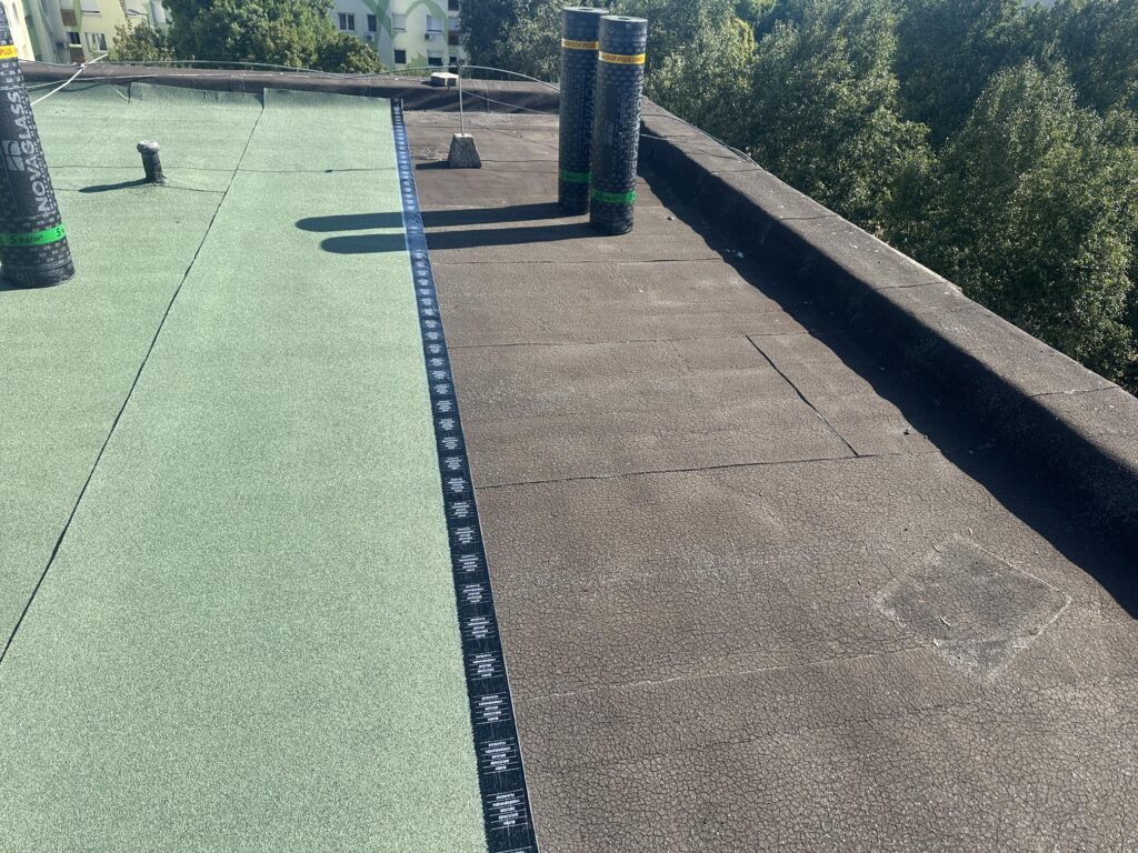 Flat roof waterproofing work viewed from above.