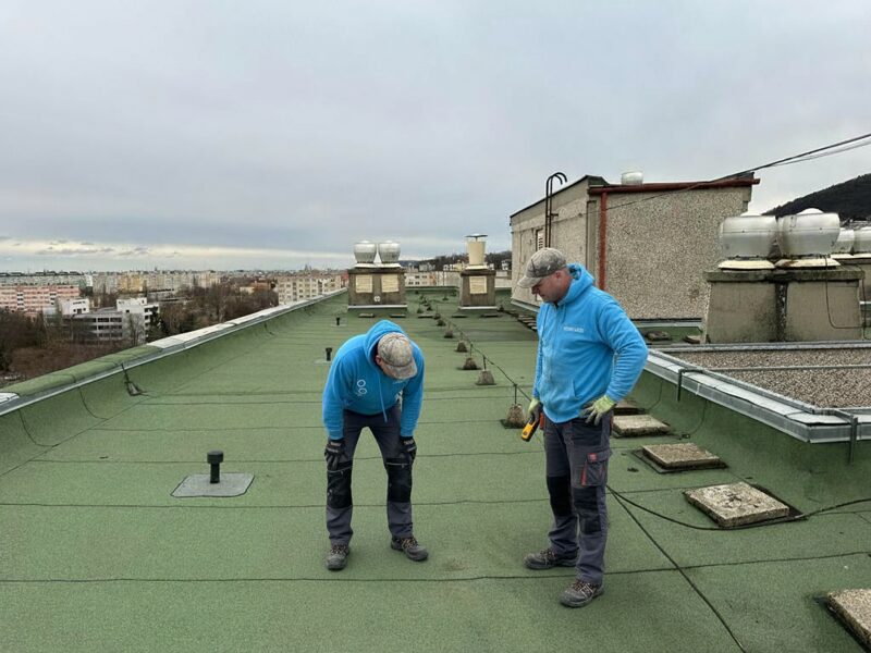 Flat roof waterproofing work viewed from above.