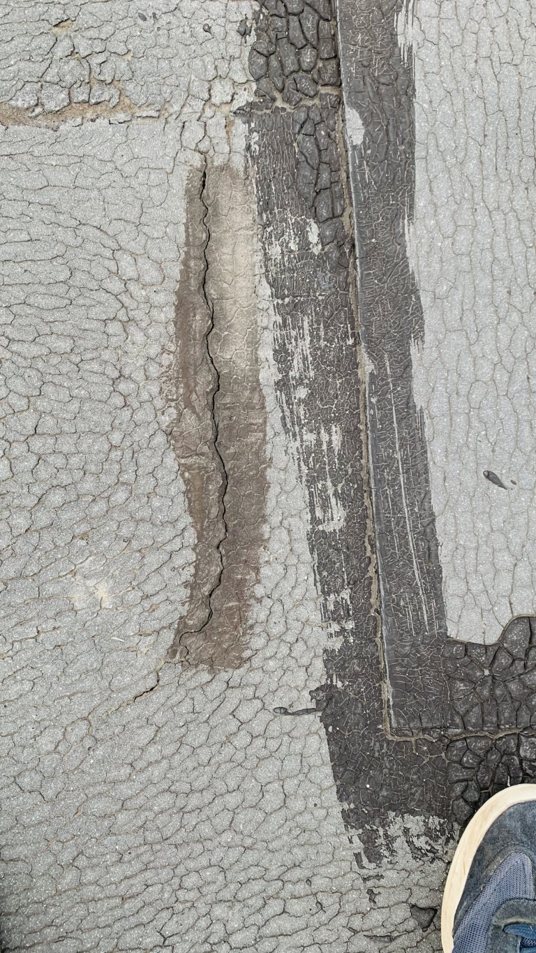Flat roof waterproofing work viewed from above.