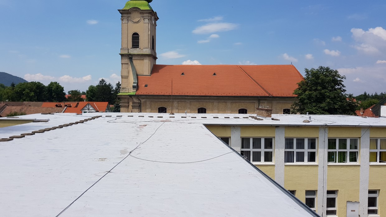 Flat roof waterproofing work viewed from above.