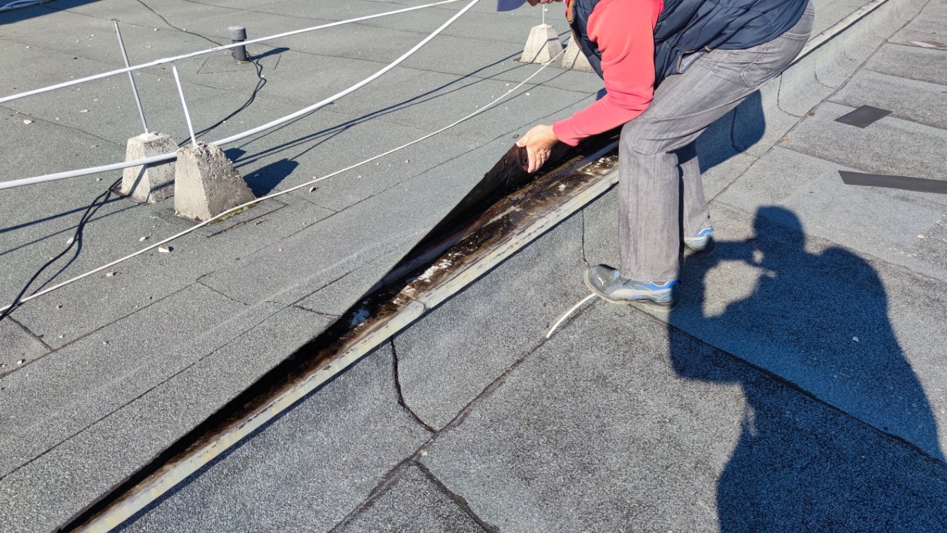 Flat roof waterproofing work viewed from above.