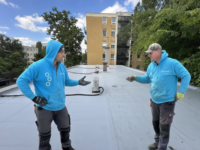 Flat roof waterproofing work viewed from above.