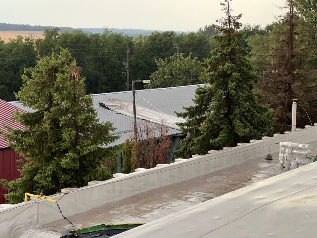 Flat roof waterproofing work viewed from above.