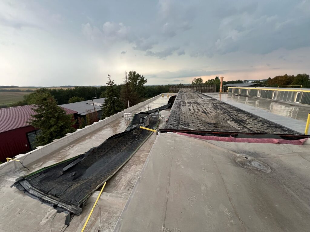 Flat roof waterproofing work viewed from above.