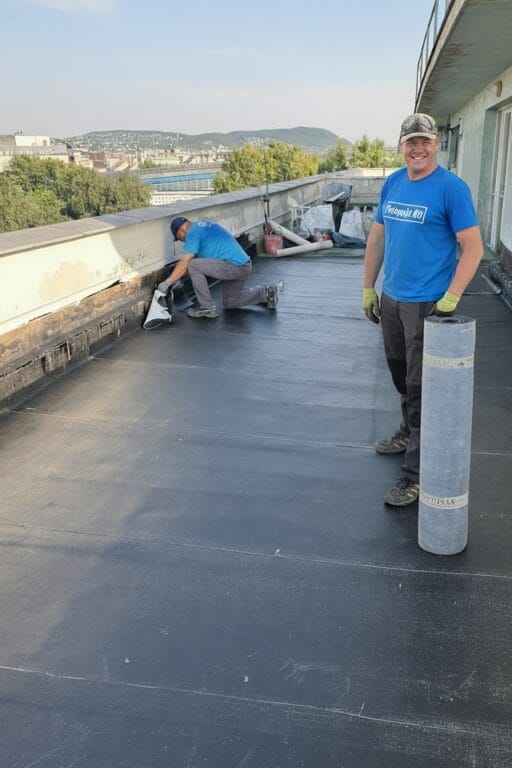 Flat roof waterproofing work viewed from above.