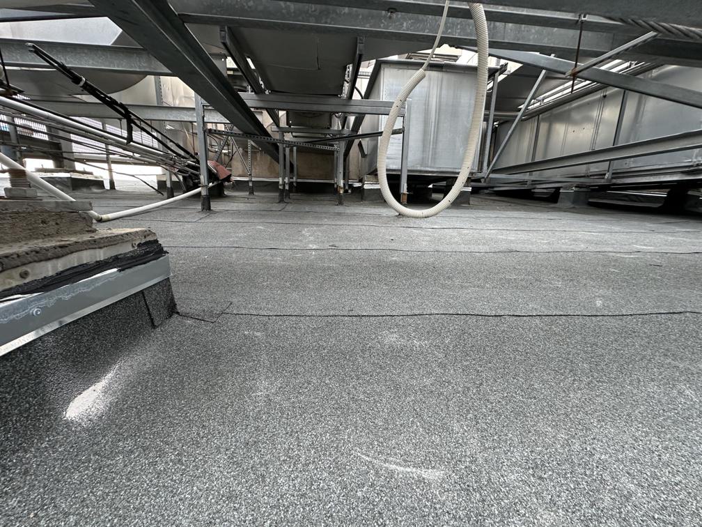 Flat roof waterproofing work viewed from above.