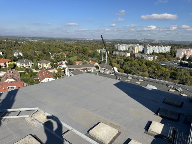 Flat roof waterproofing work viewed from above.