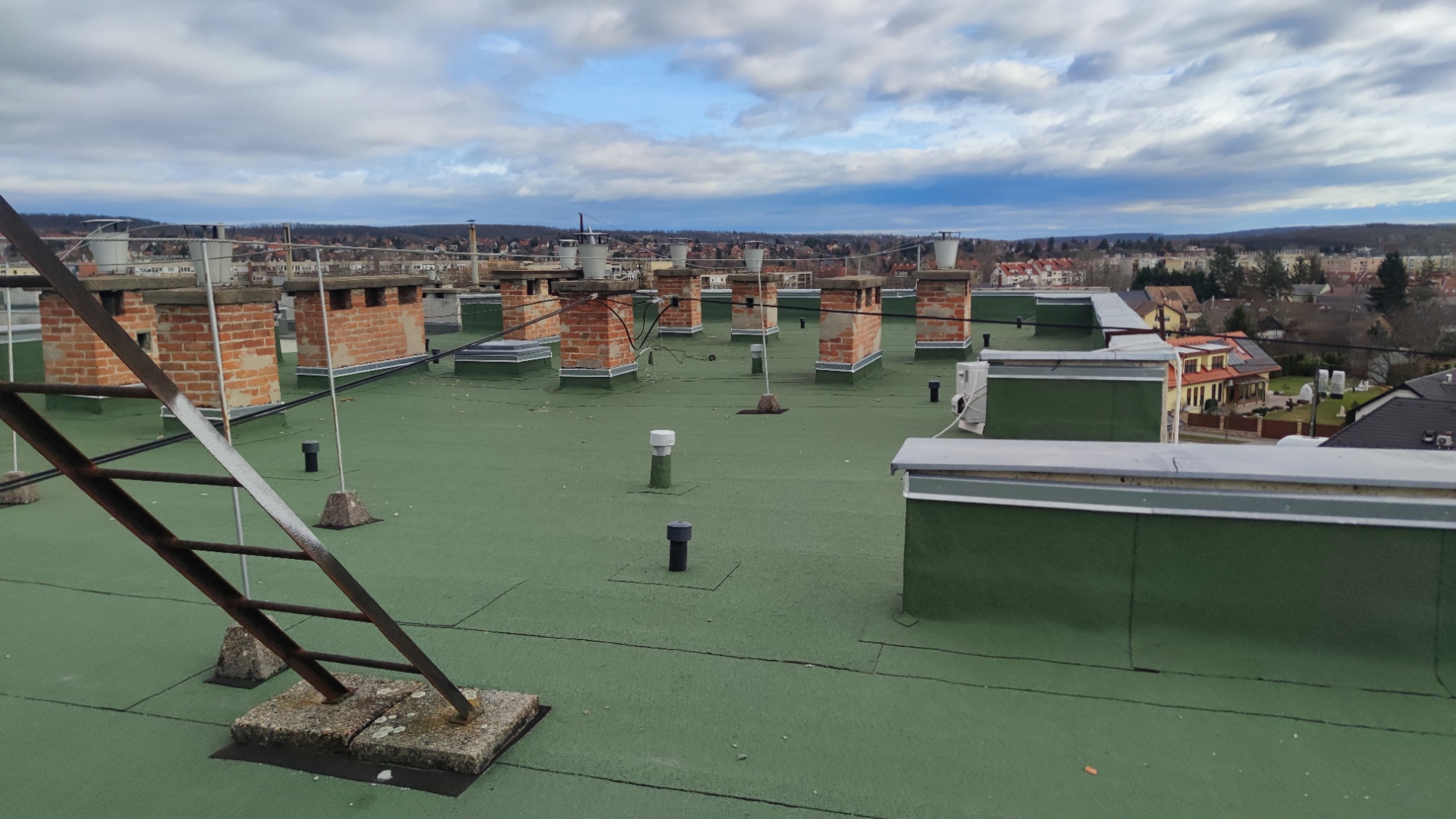 Flat roof waterproofing work viewed from above.