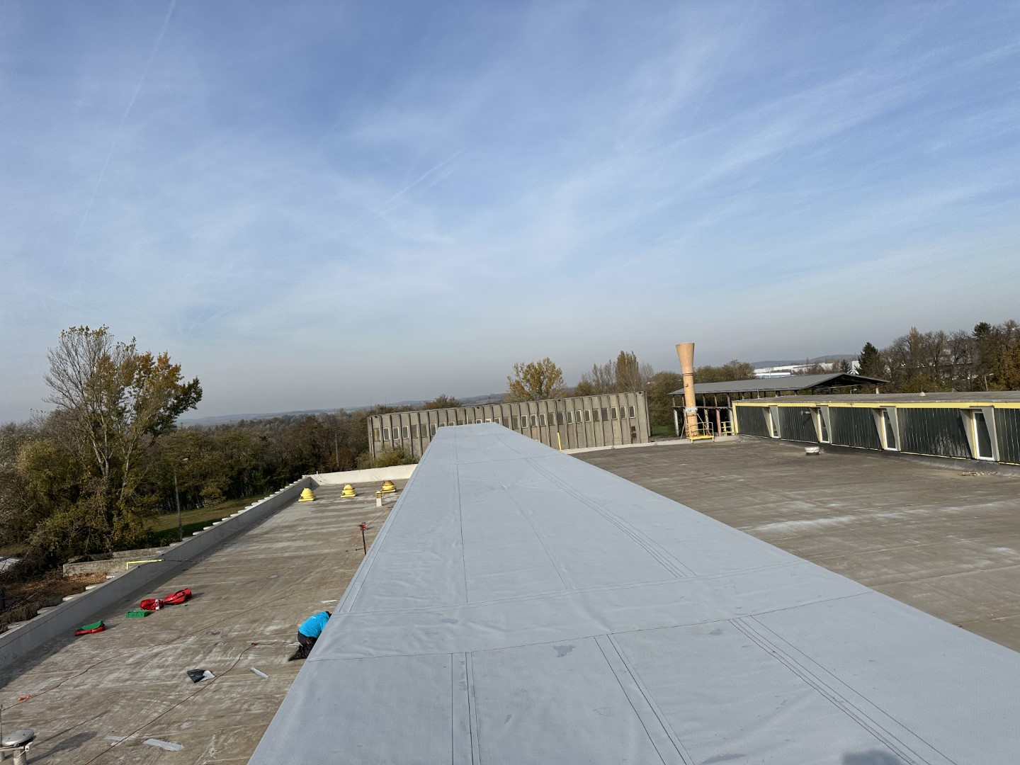 Flat roof waterproofing work viewed from above.