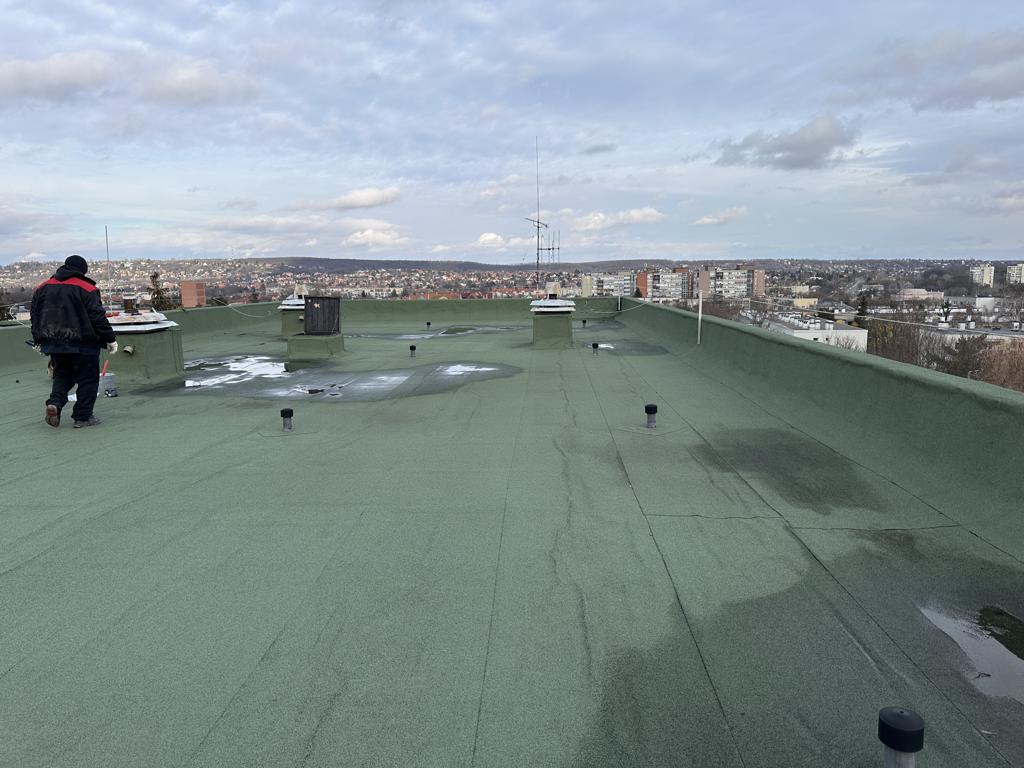 Flat roof waterproofing work viewed from above.