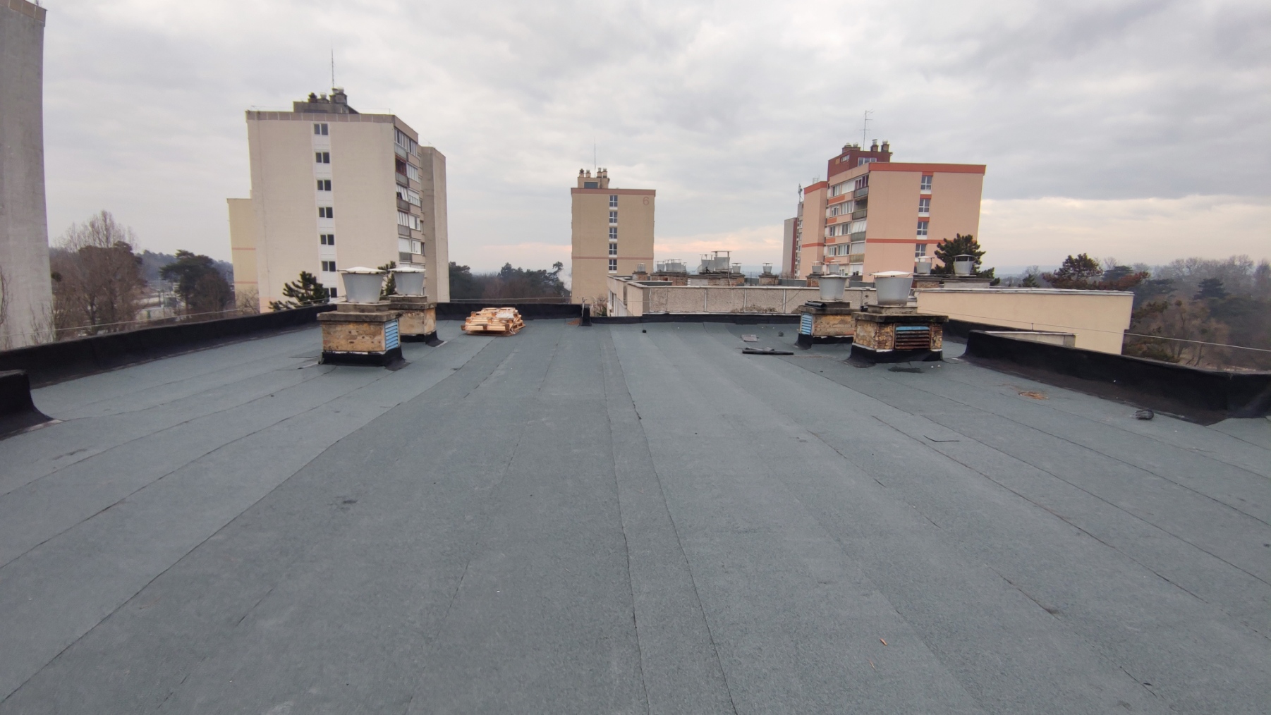 Flat roof waterproofing work viewed from above.