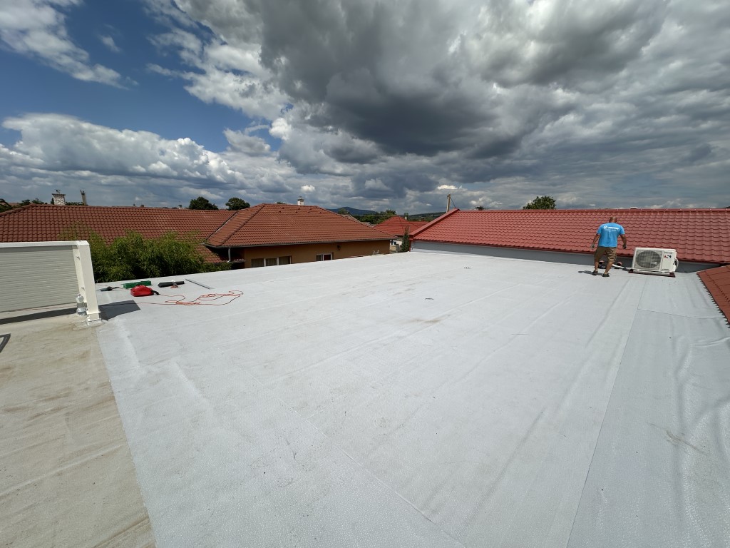 Flat roof waterproofing work viewed from above.