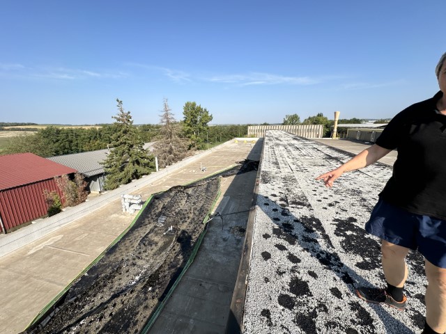 Flat roof waterproofing work viewed from above.