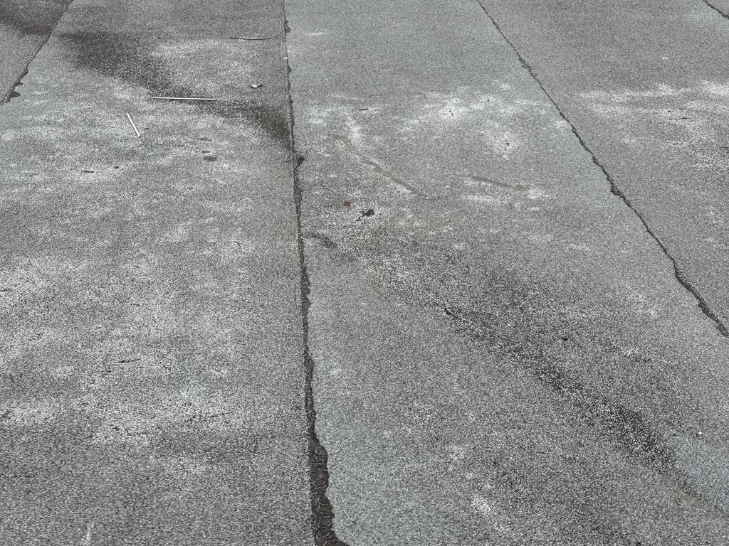 Flat roof waterproofing work viewed from above.