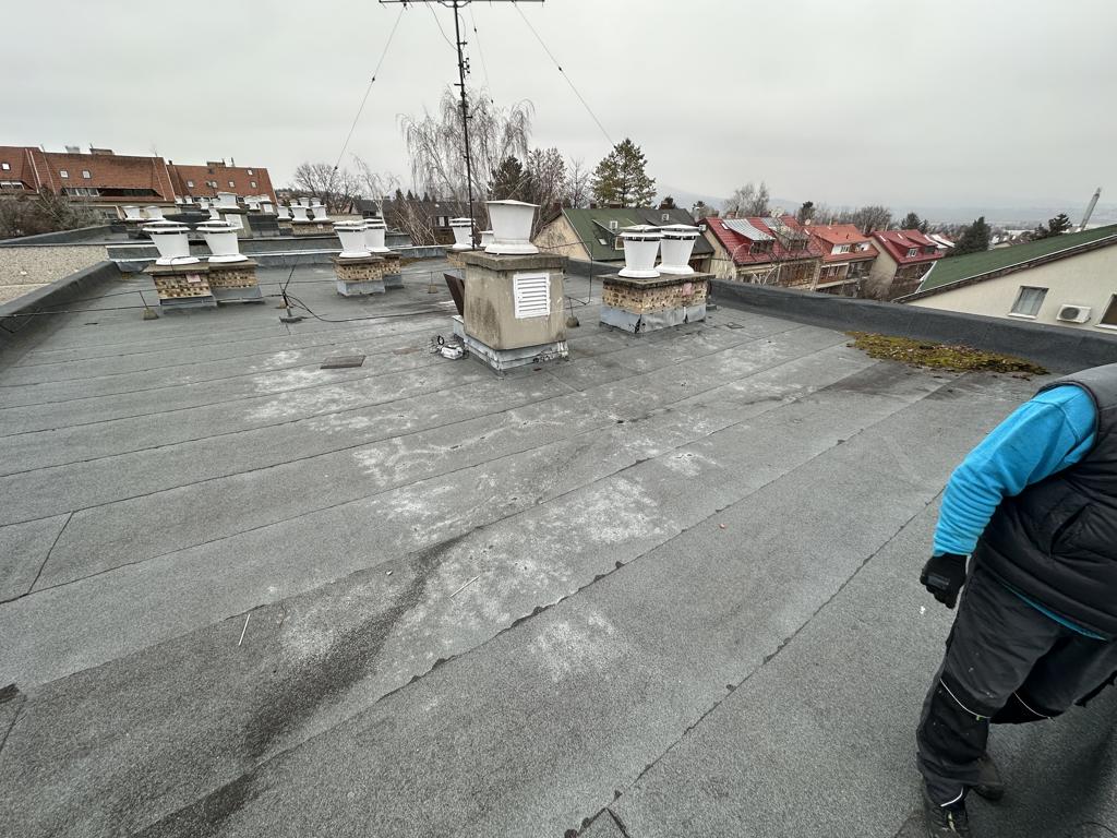 Flat roof waterproofing work viewed from above.
