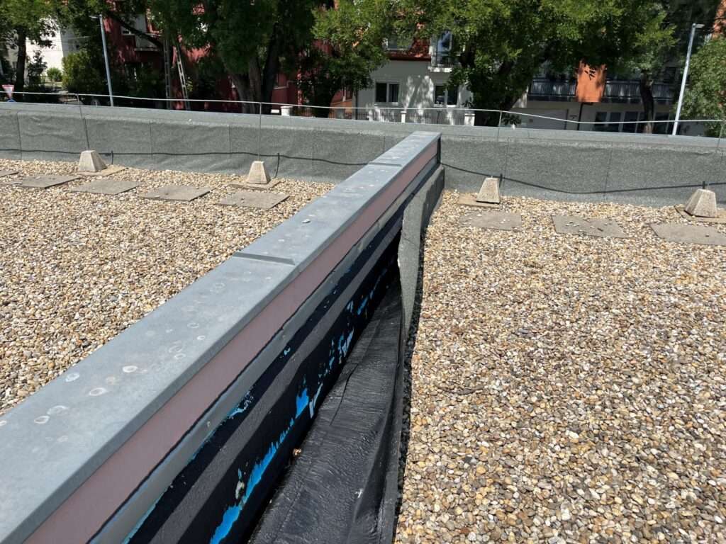 Flat roof waterproofing work viewed from above.