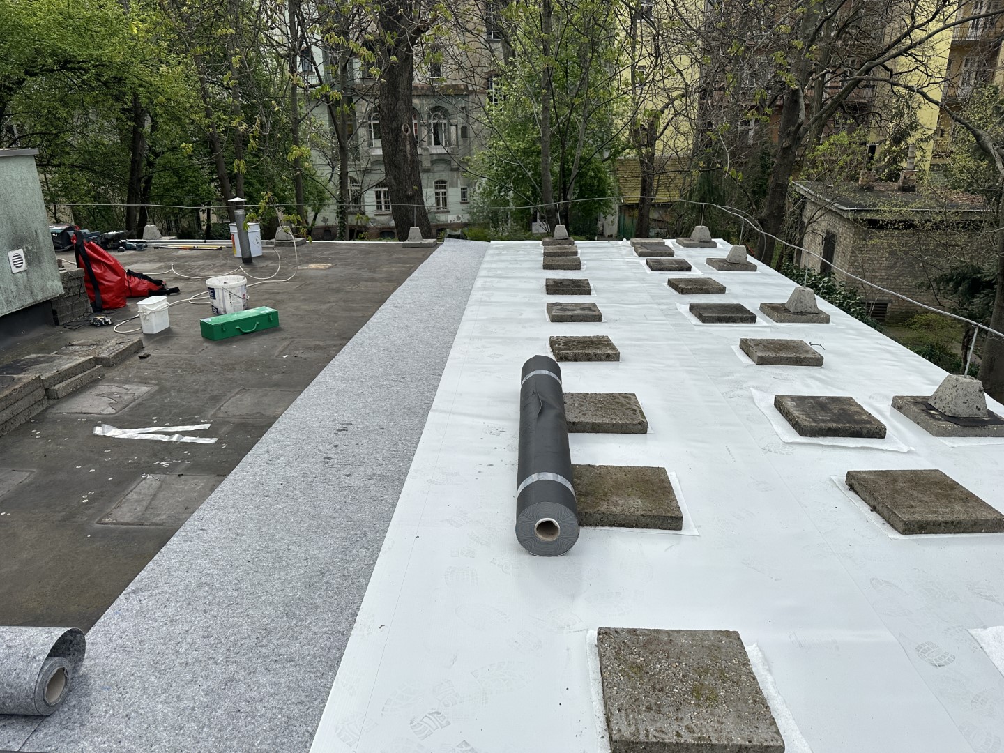Flat roof waterproofing work viewed from above.