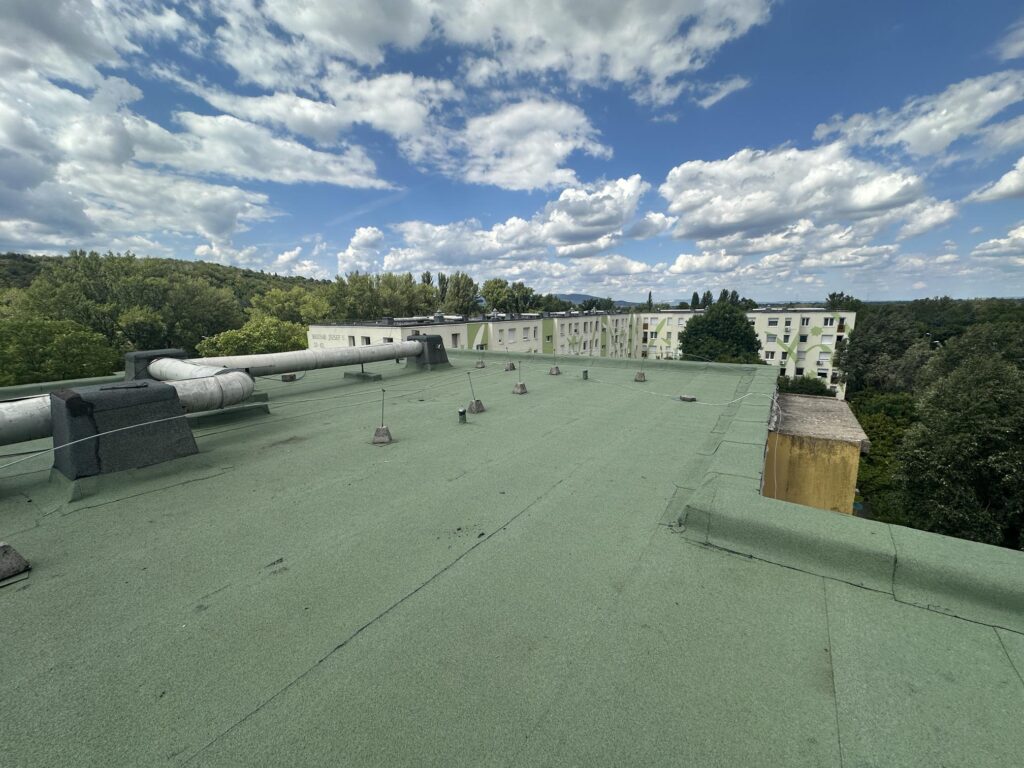 Flat roof waterproofing work viewed from above.