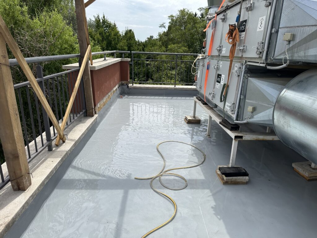 Flat roof waterproofing work viewed from above.