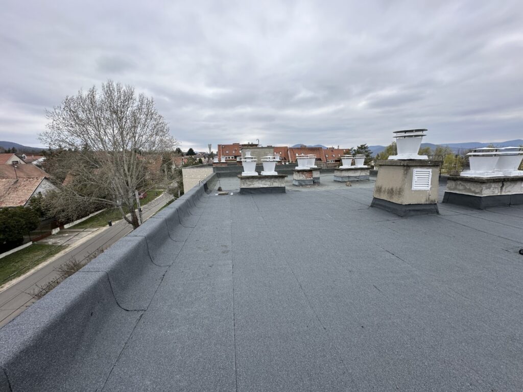 Flat roof waterproofing work viewed from above.