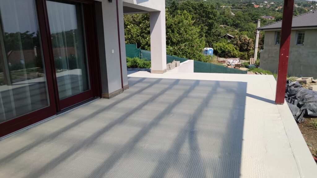 Flat roof waterproofing work viewed from above.