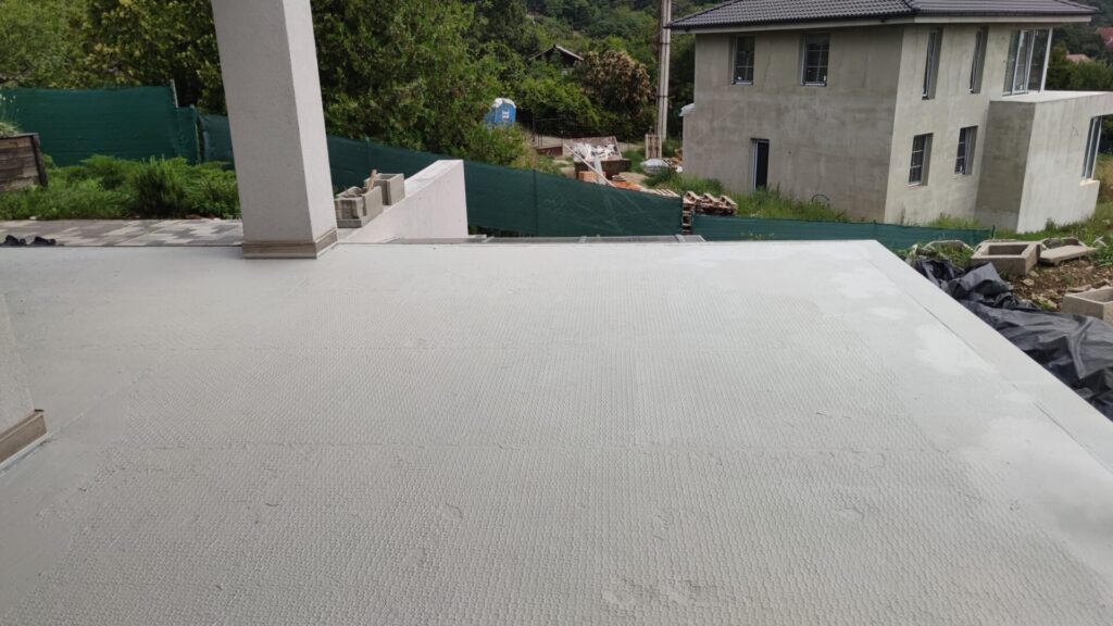 Flat roof waterproofing work viewed from above.