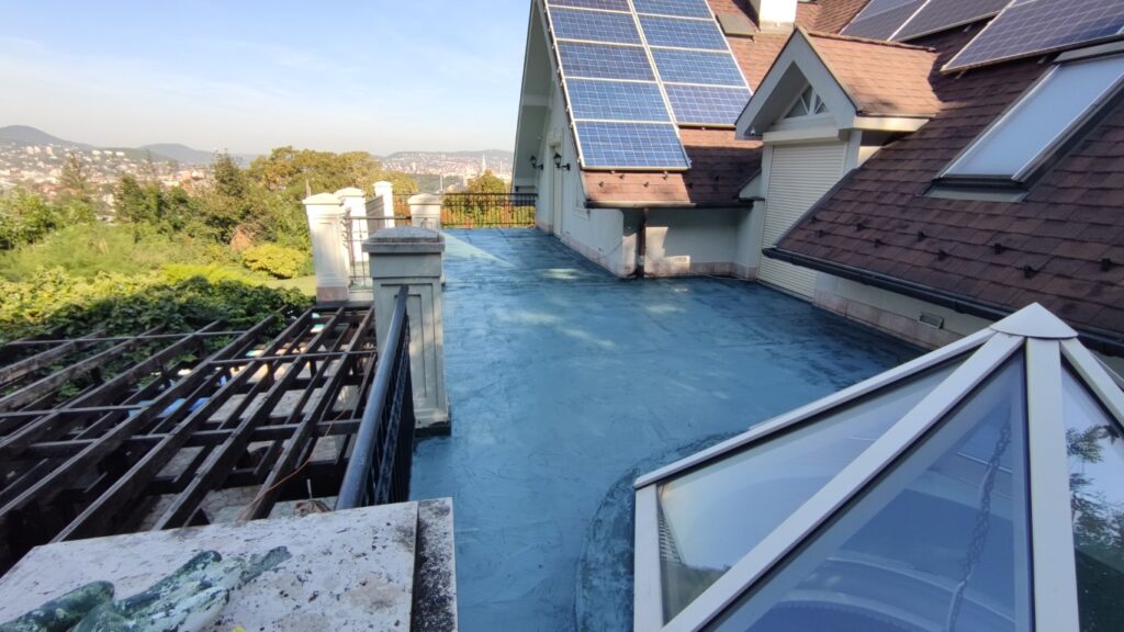 Flat roof waterproofing work viewed from above.