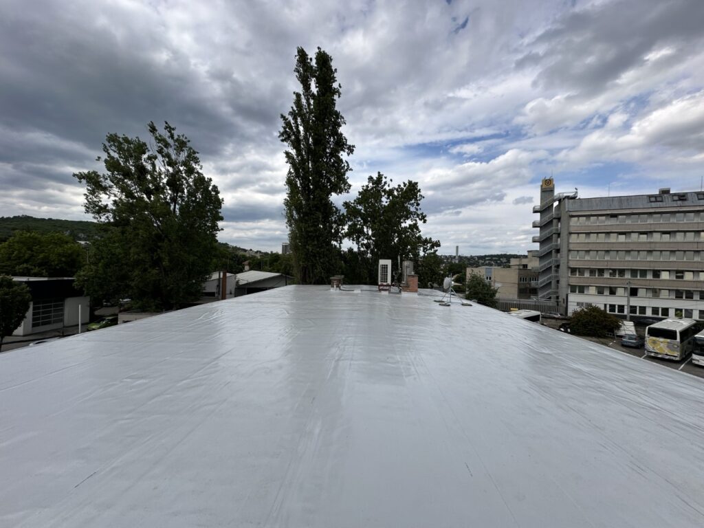 Flat roof waterproofing work viewed from above.