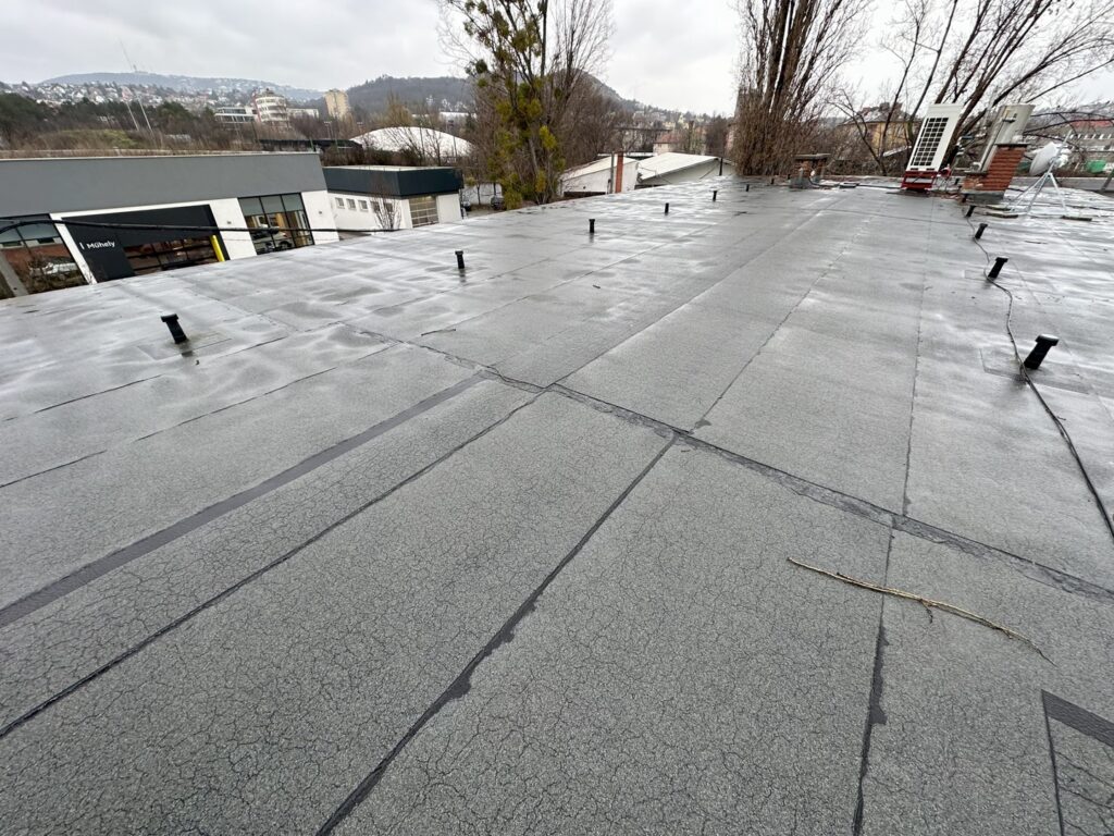Flat roof waterproofing work viewed from above.