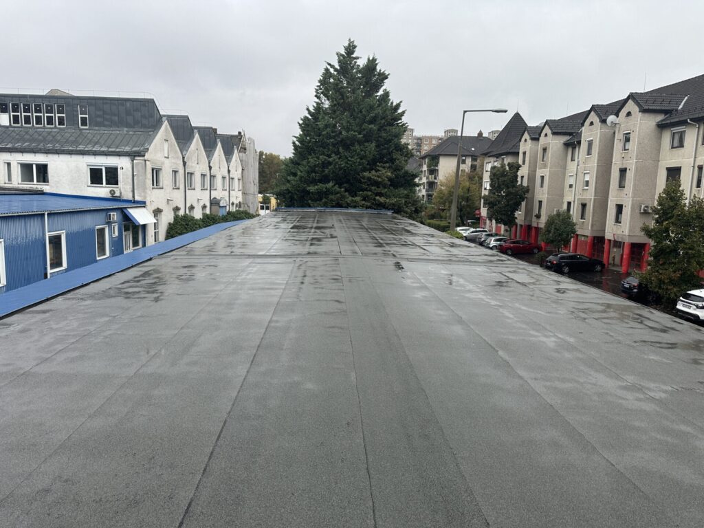 Flat roof waterproofing work viewed from above.