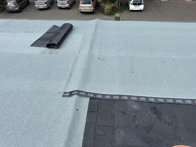Flat roof waterproofing work viewed from above.