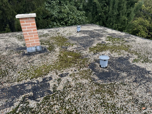 Flat roof waterproofing work viewed from above.