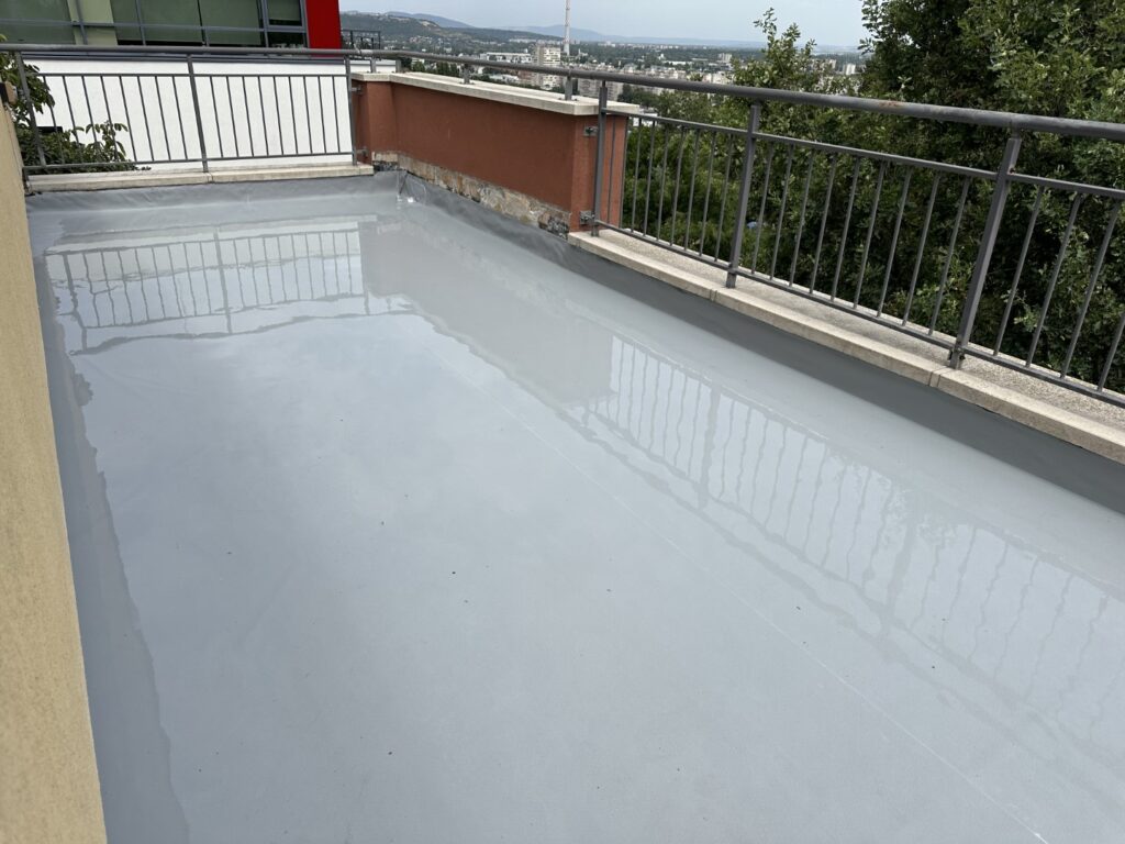 Flat roof waterproofing work viewed from above.