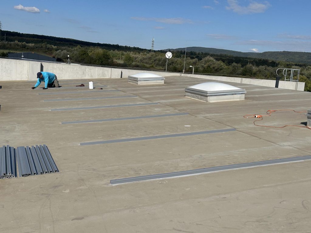 Flat roof waterproofing work viewed from above.