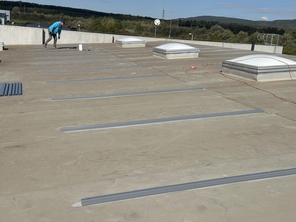 Flat roof waterproofing work viewed from above.