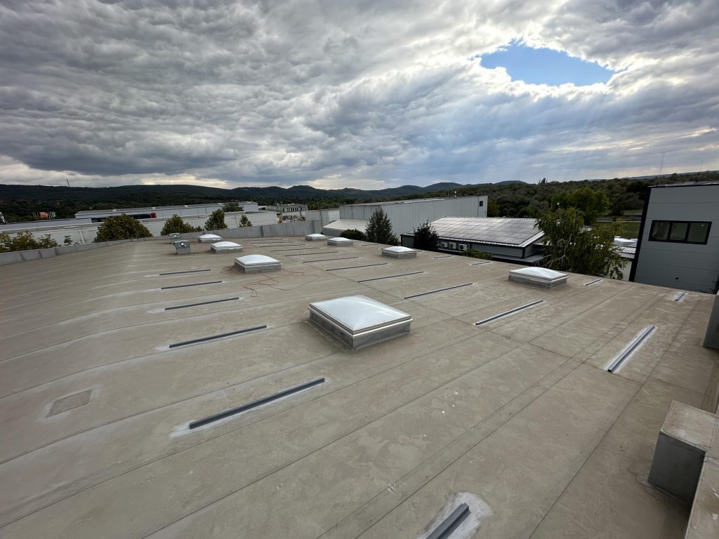 Flat roof waterproofing work viewed from above.