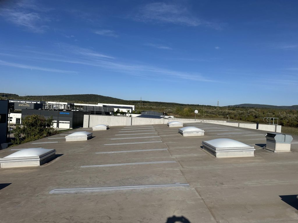 Flat roof waterproofing work viewed from above.