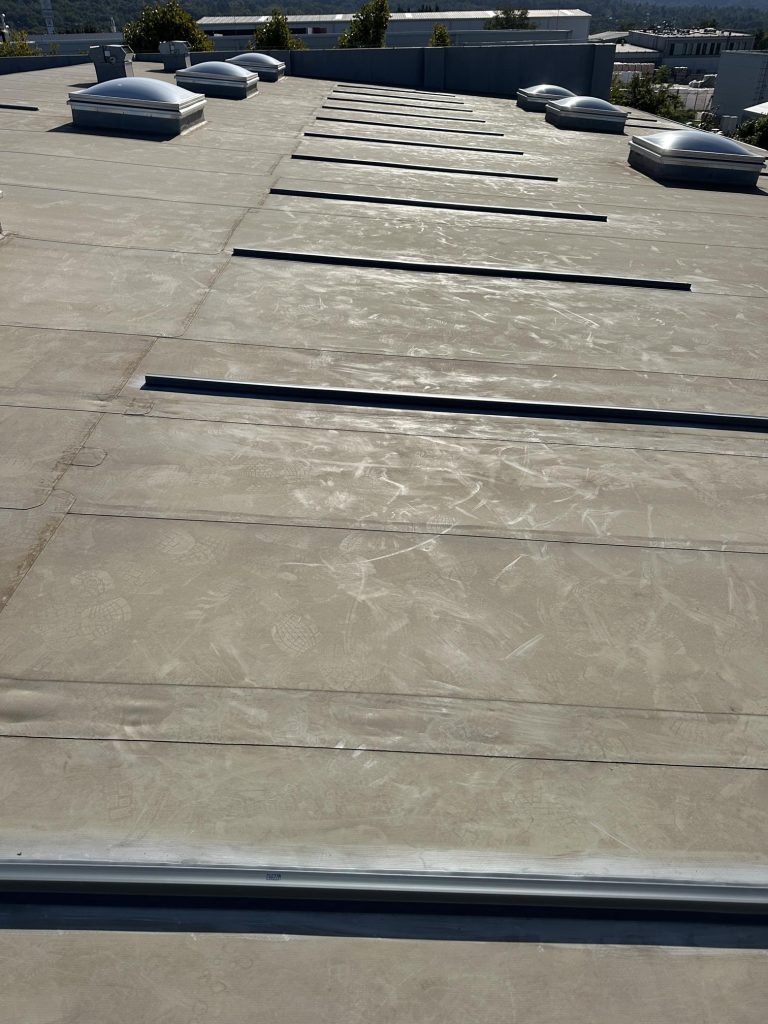 Flat roof waterproofing work viewed from above.
