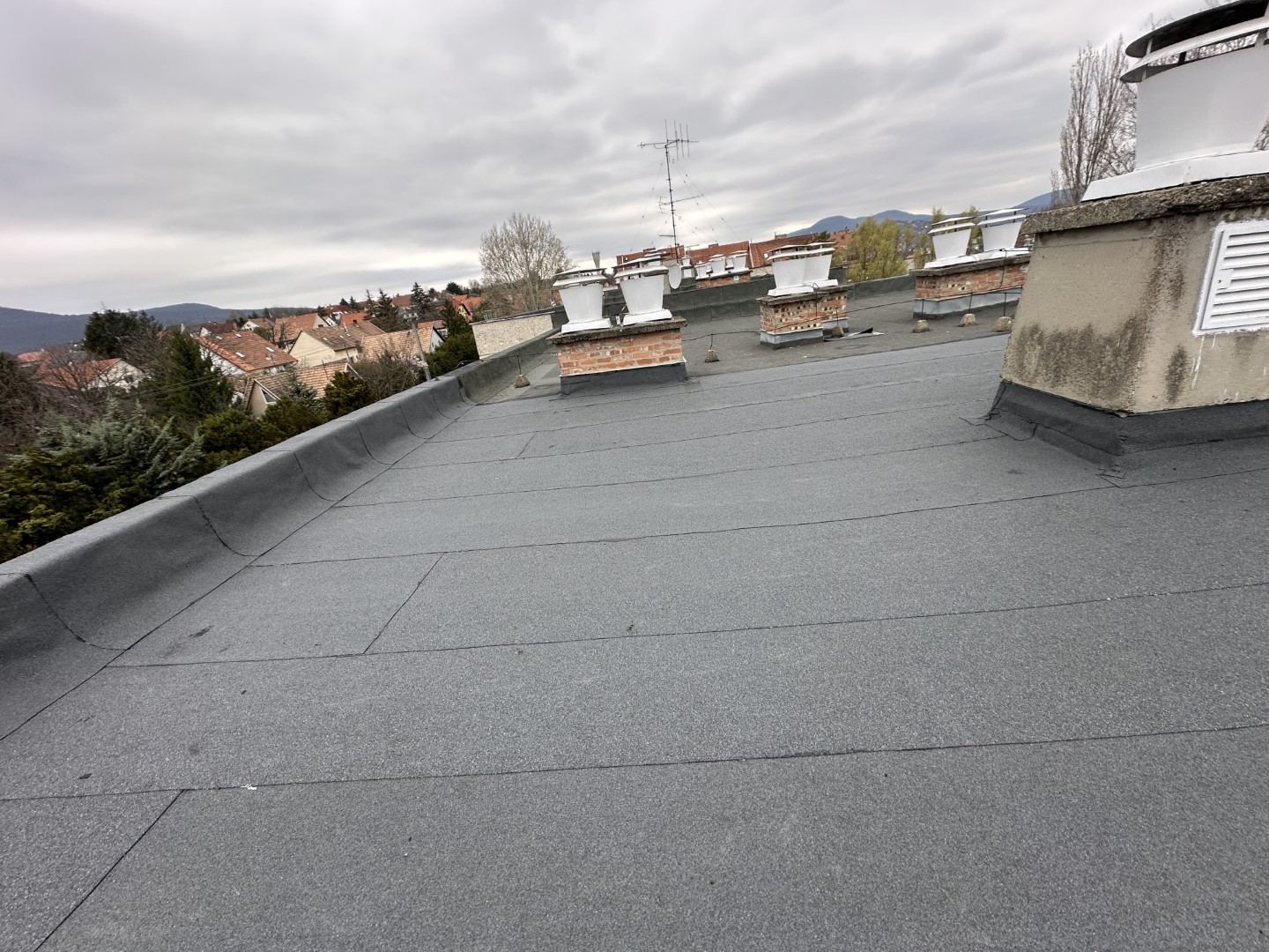 Flat roof waterproofing work viewed from above.