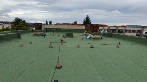 Flat roof waterproofing work viewed from above.